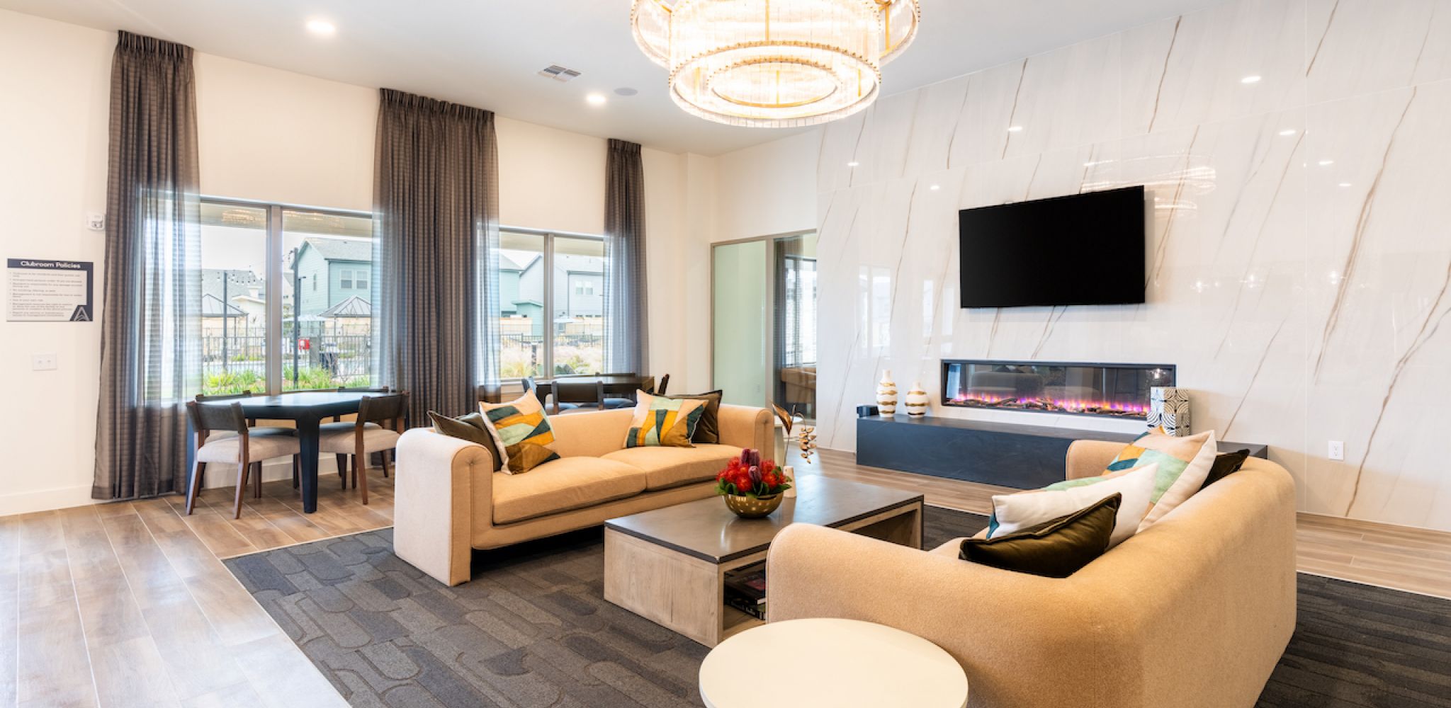 Artesia at Medina Valley pool areas surrounded by lounge chairs, parasols, and vibrant gardens.