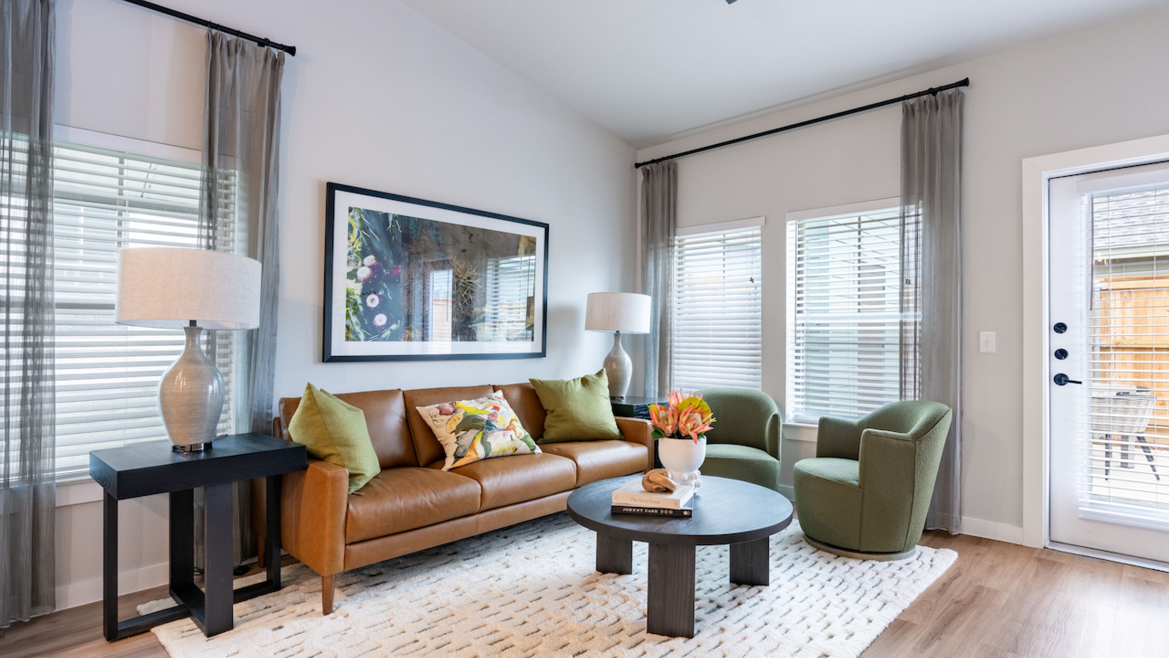Artesia at Medina Valley kitchen with white cabinets, a kitchen island, and stainless steel appliances.