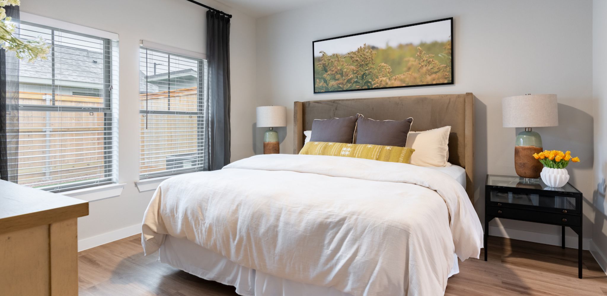 Artesia at Medina Valley Happy family having fun in the bedroom while they lie on bed